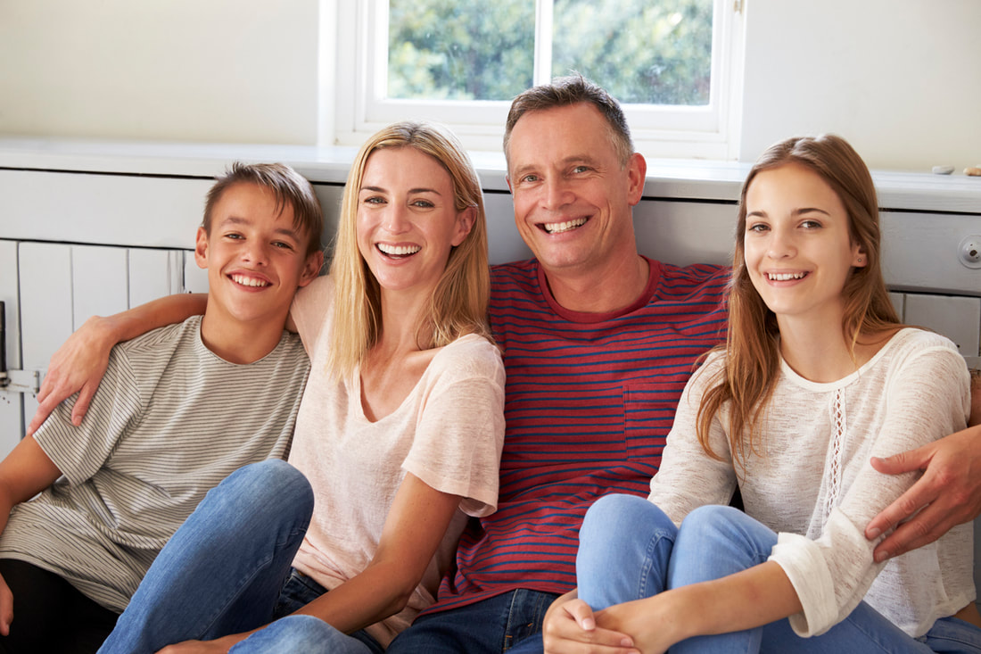 Smiling Family On Couch