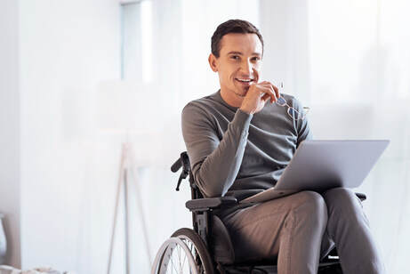 Picture of man in wheelchair with laptop